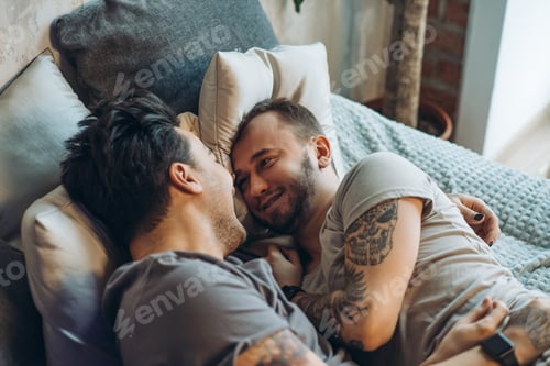 Preview: A homosexual couple on bed in studio with loft interior