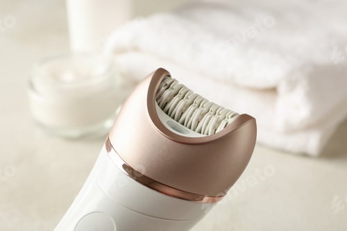 Preview: Concept of skincare with epilator on white table