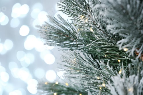 Preview: Decorated Christmas tree against blurred lights on background. Bokeh effect