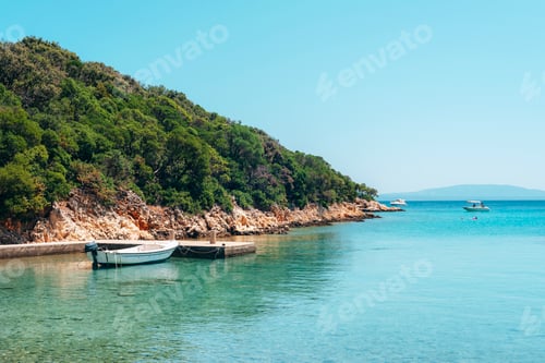 Preview: Boat in the blue sea against the backdrop of the seashore. Summer vacation travel concept