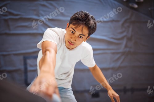 Preview: Close Up Of Determined Man Tackling Climbing Wall At Indoor Activity Centre
