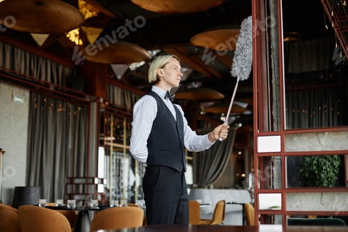 Preview: Elegant young man as server wearing tuxedo uniform