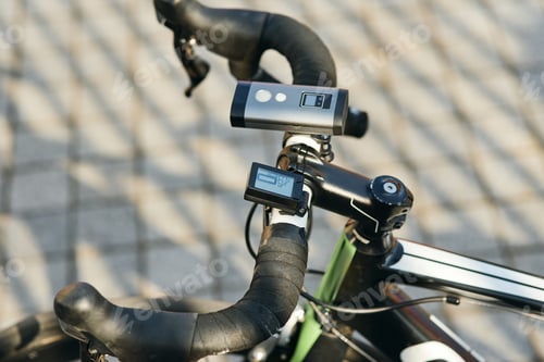 Preview: Close up shot of professional bike handlebar with equipment and accessories