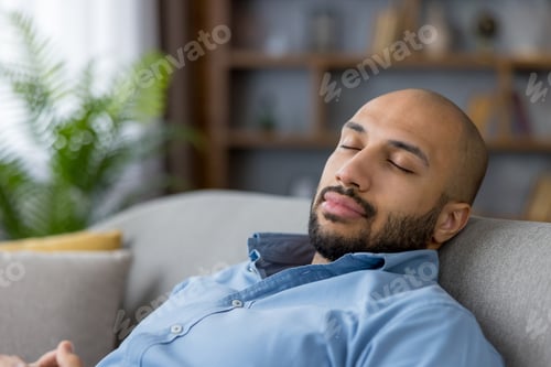 Preview: Young man relaxing resting sleeping on living room couch