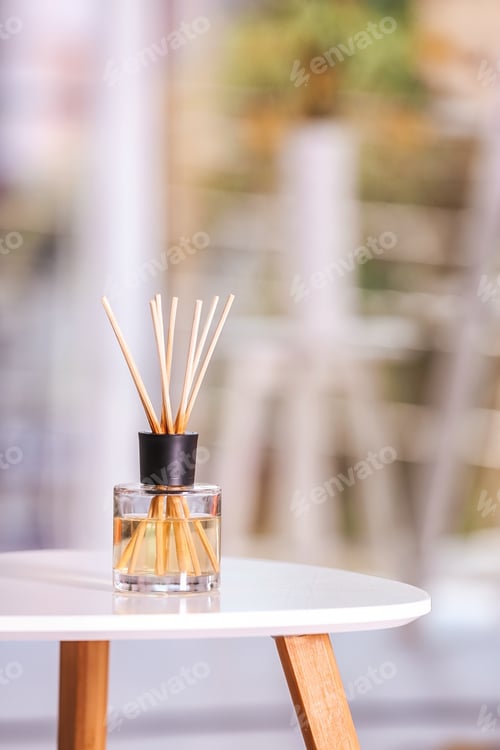 Preview: Aromatic reed air freshener on table against blurred background