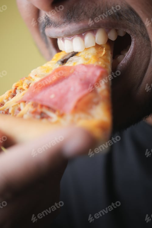 Preview: Enjoying a slice of delicious pizza at home during lunchtime