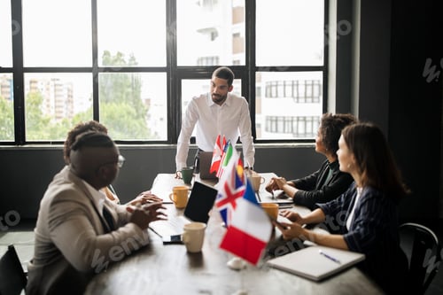 Preview: Arabic Businessman At Table Looking At Multiethnic Employees At Office