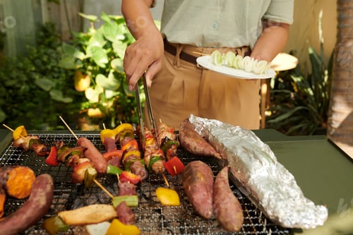Preview: Man Taking Kebabs from Grill