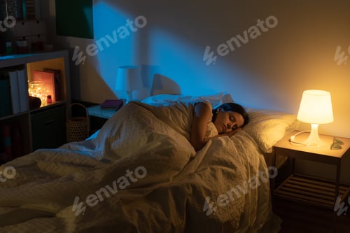 Preview: Beautiful girl suffering from insomnia lying in her bed with Blue Colors from the moon.