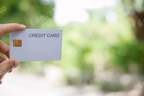 Preview: Credit Card. hand holding credit card with green nature background and copy space concept online sho