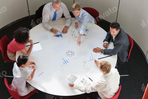 Preview: Business colleagues working together in meeting room, high angle view