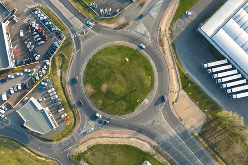 Preview: Aerial view of road roundabout intersection with moving heavy traffic.
