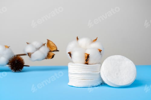 Preview: Cotton discs stack on blue paper background