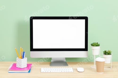 Preview: Stylish workplace with modern computer on wooden desk near light green wall