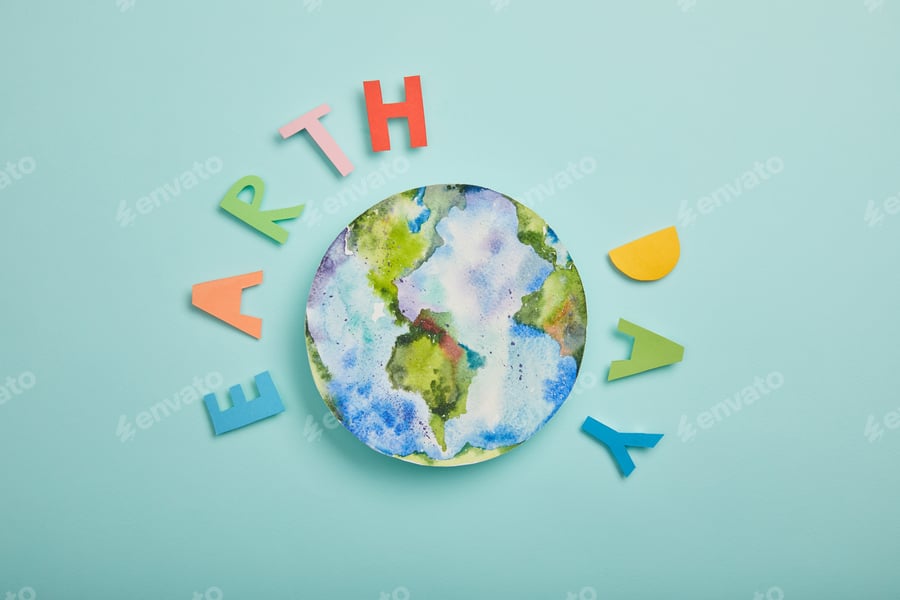 Cover for top view of colorful paper letters and planet picture on turquoise background, earth day concept