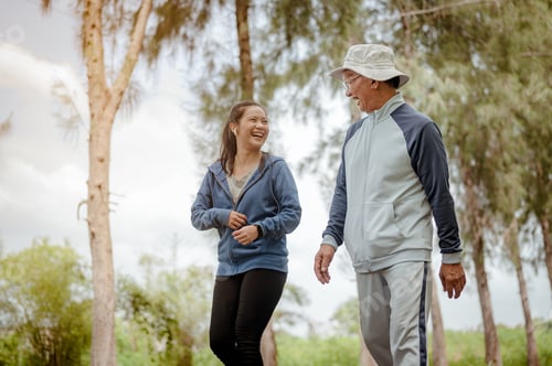 Preview: A woman and grandfather are walking jogging on the street at the park.
