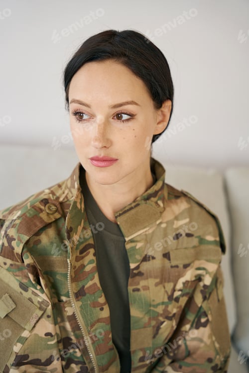 Preview: Portrait of an attractive dark-haired young woman in camouflage jacket