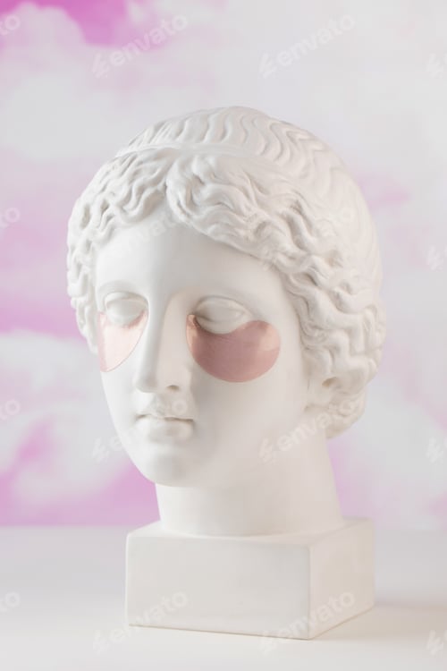 Preview: Hydrogel pink patches on the plaster head of Aphrodite on a pink background. Beauty concept.