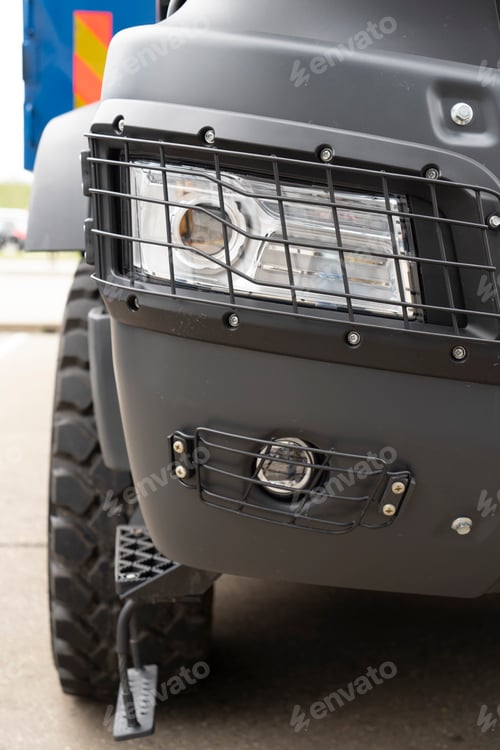 Preview: Headlight of the truck under the protective grill
