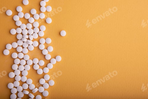Preview: Closeup shot of pile of pills isolated on an orange background
