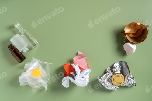 Preview: Different types waste, garbage of plastic, metal, organic, paper, glass on green background. Waste