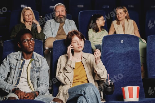 Preview: Young Woman Talking On Phone At Cinema