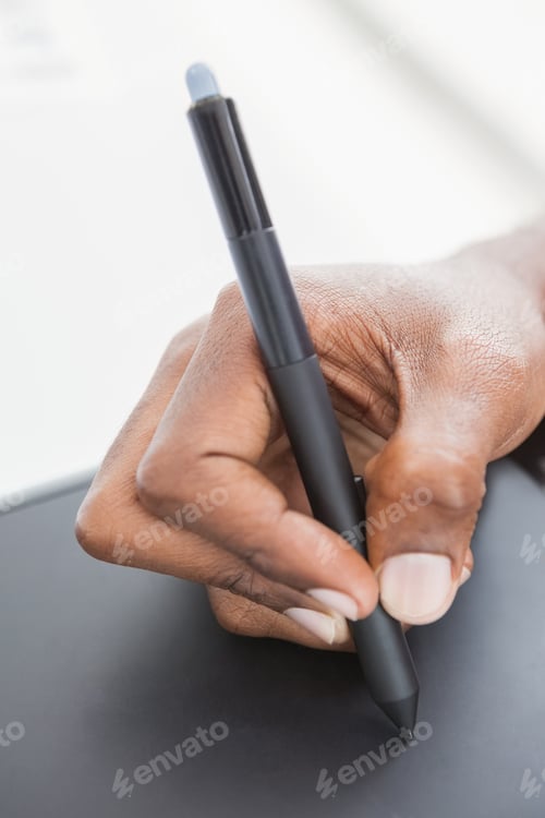 Preview: Hand of designer using stylus and digitizer in the office