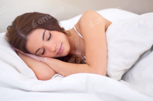 Preview: Peaceful dreaming. An attractive young woman sleeping in her bed.