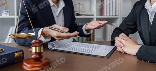 Preview: Businessman and lawyer discussing business contract document for legal advice in lawyer's office.