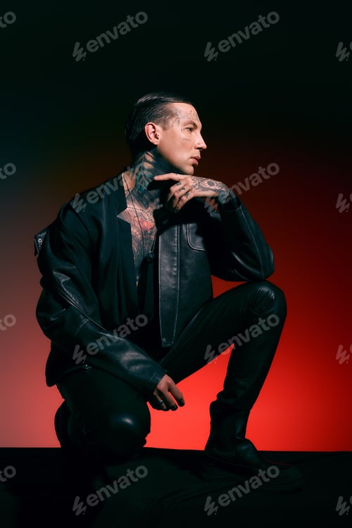 Preview: Stylish young man poses confidently in a striking artistic portrait with dramatic lighting