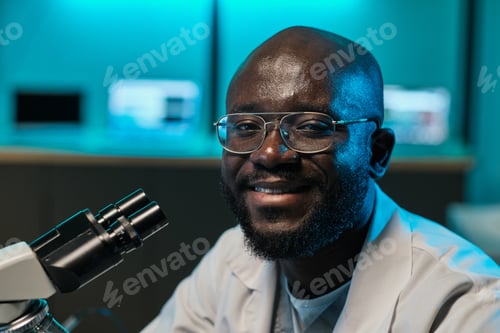 Preview: Happy young African researcher looking at camera