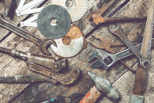 Preview: Collection of assorted hand tools and equipment scattered on a wooden workbench in a workshop