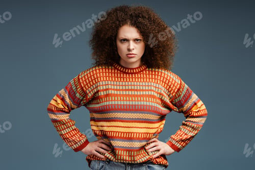 Preview: Angry sad woman with curly hair wearing casual cheerful sweater looking at camera standing isolated