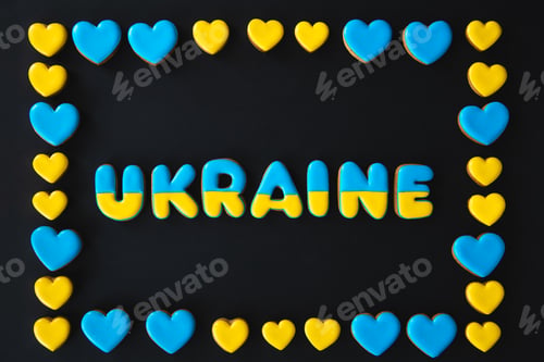 Preview: The word Ukraine on a black background, made with handmade gingerbread.