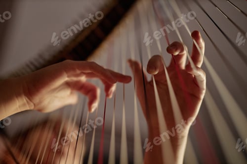 Preview: Fingers of Woman Playing Harp Plucking Strings with Fingers on Stage