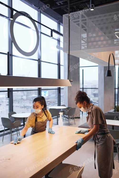 Preview: Two Workers Sanitizing Tables in Cafe