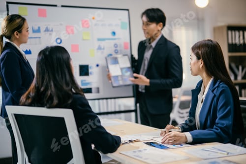 Preview: Team of asian business professionals are having a meeting, analyzing data on charts and graphs, and