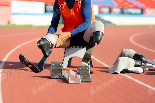 Preview: Asian para-athletes with prosthetic blades sprint on a running track at stadium.