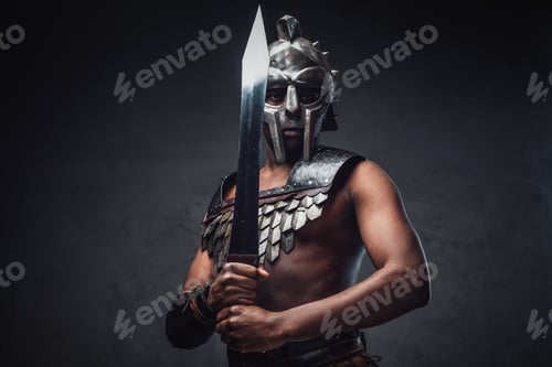 Preview: Proud antique gladiator with sword against dark background