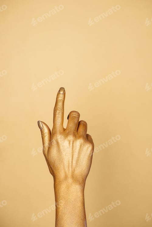 Preview: partial view of female painted hand isolated on gold with copy space