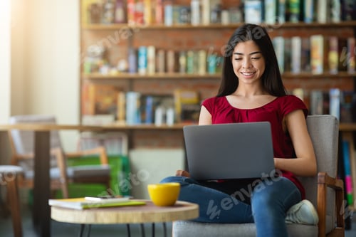 Preview: Smiling korean girl using laptop for online work or studies at cafe