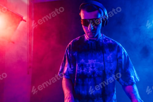 Preview: Club DJ playing music at party wearing sunglasses
