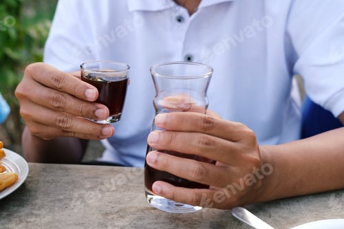Preview: Man Holding Hot Coffee Cup at Outdoor Cafe