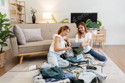 Preview: Friend using tablet for booking vacation at travel agency or making hotel reservation online and