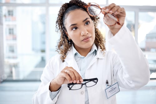Preview: Glasses, vision and black woman eye doctor check lens and frame for healthcare and optometry. Medic