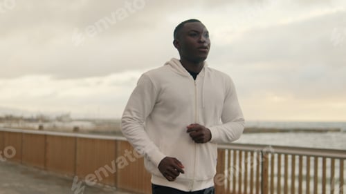 Preview: Athlete running along the seaside promenade, cardio workout