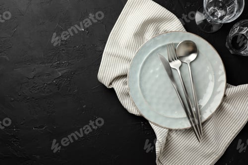 Preview: Stylish setting with cutlery, napkin and plate on dark textured table, flat lay. Space for text