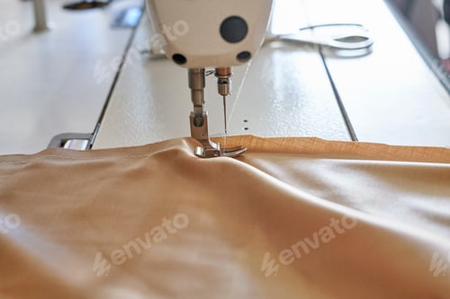 Preview: Closeup shot of a sewing process in the phase of overstitching