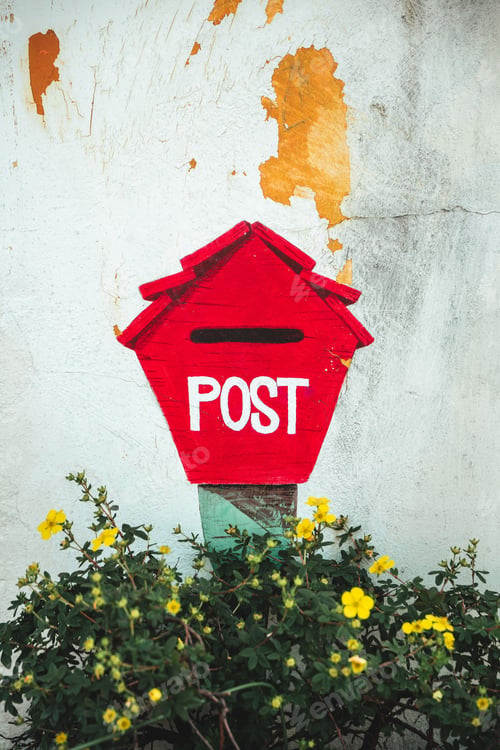 Preview: Vertical shot of a red post box against a rustic background