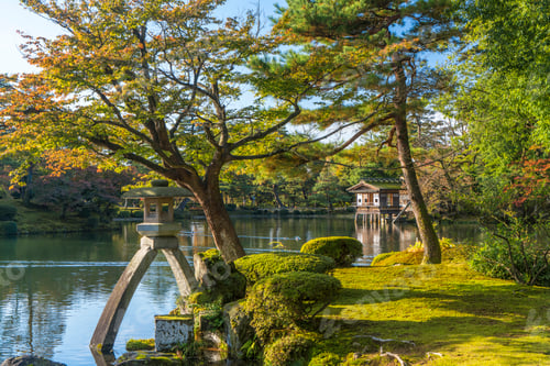 Preview: Landscape garden in autumn, with trees and pond, a boathouse in the distance.